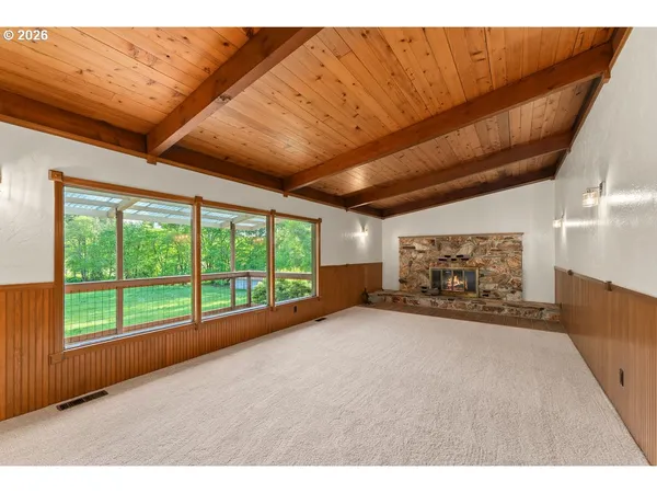 a view of a livingroom with an empty space and a fireplace