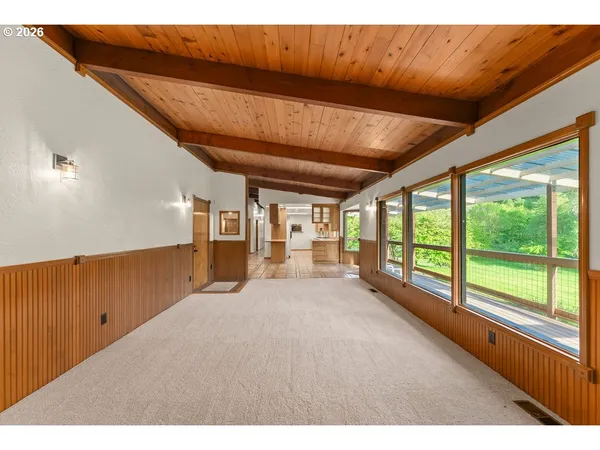 a big room with wooden floor and windows