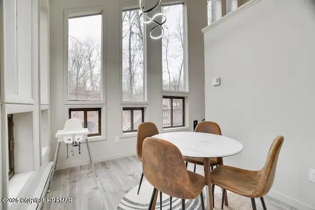 a view of a dining room with furniture and wooden floor