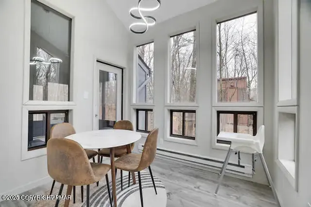 a view of a dining room with furniture and chandelier