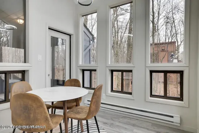 a view of a dining room with furniture and a window