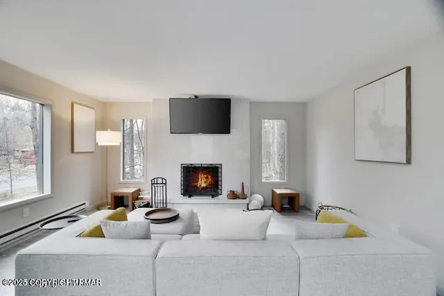 a living room with furniture and a fireplace