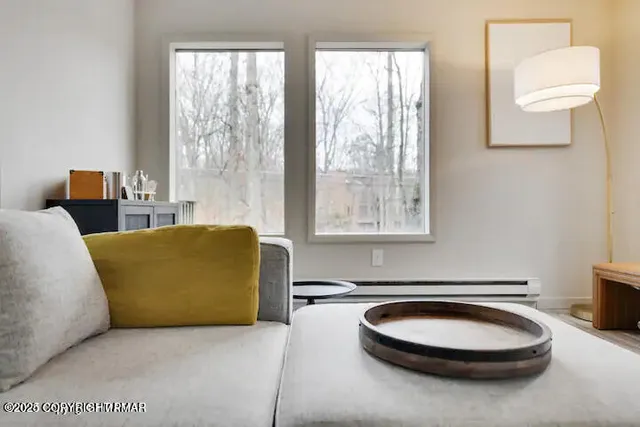 a living room with furniture a window and a lamp