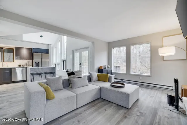 a living room with furniture and a flat screen tv