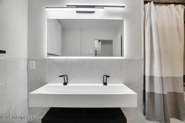 a bathroom with a sink and mirror