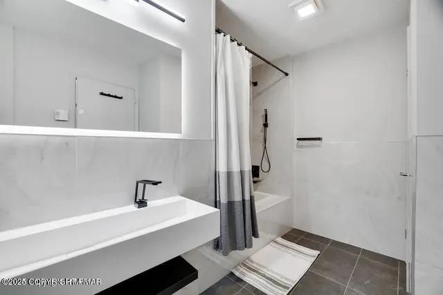 a bathroom with a sink and mirror