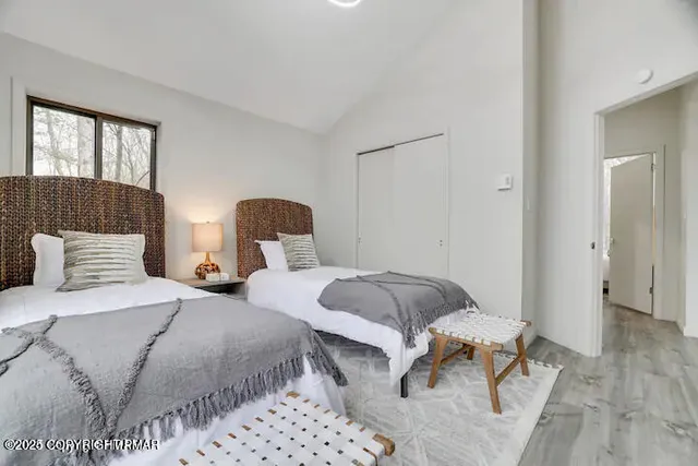 a bedroom with two beds and painting on the wall