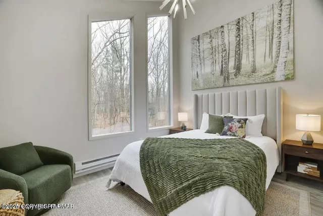 a bedroom with a bed couch and a window