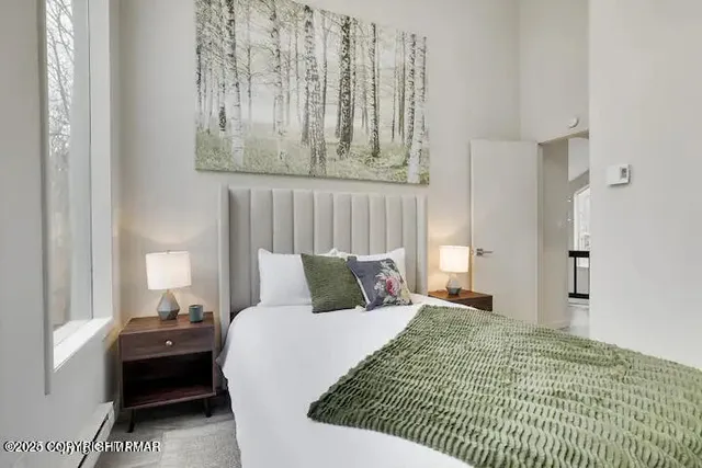 a bedroom with a bed and a window