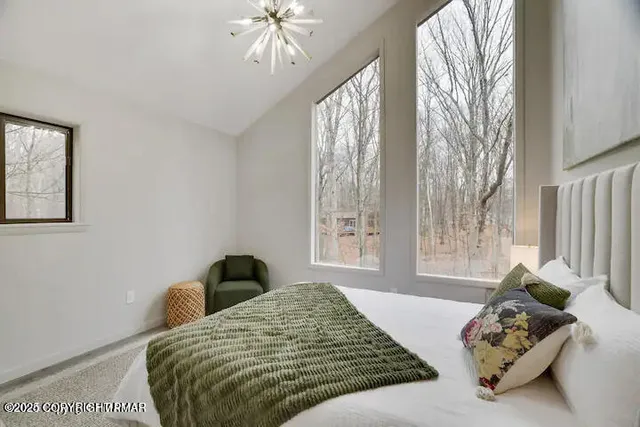 a bedroom with furniture and a window