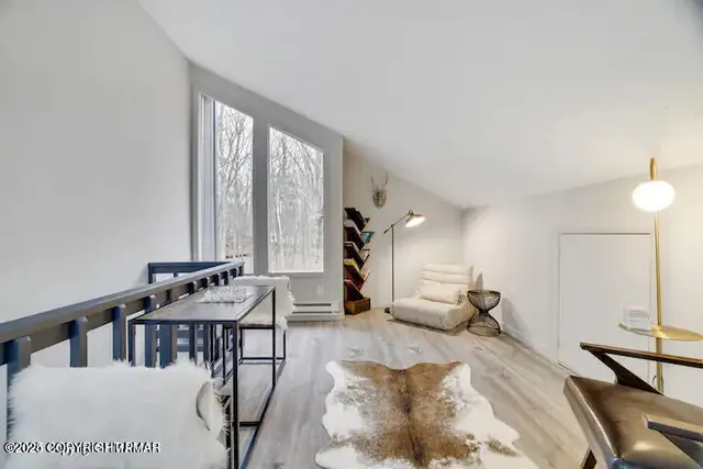 a living room with furniture and large windows