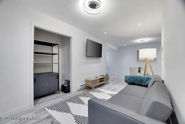 a living room with furniture and a flat screen tv