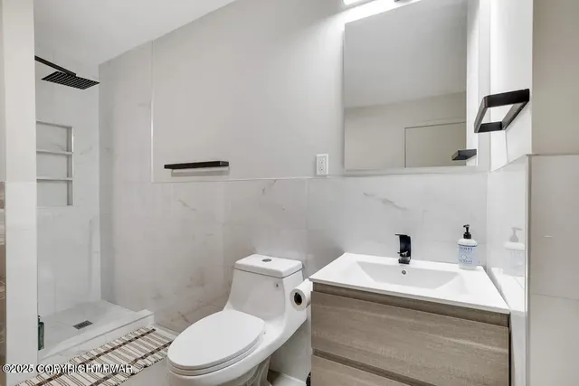 a white toilet sitting next to a bathroom sink