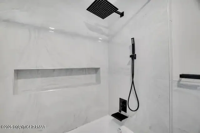 a room with a walk in closet and wooden floor