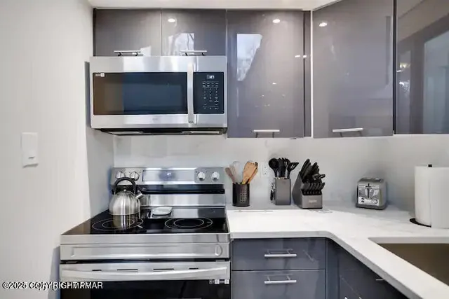 a kitchen with a stove and a microwave