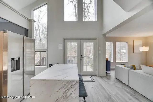 a large white room with mirror and windows