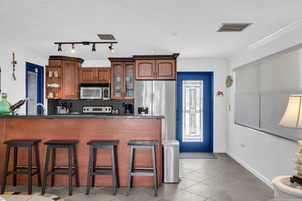 a dining room with furniture a rug and a floor to ceiling window