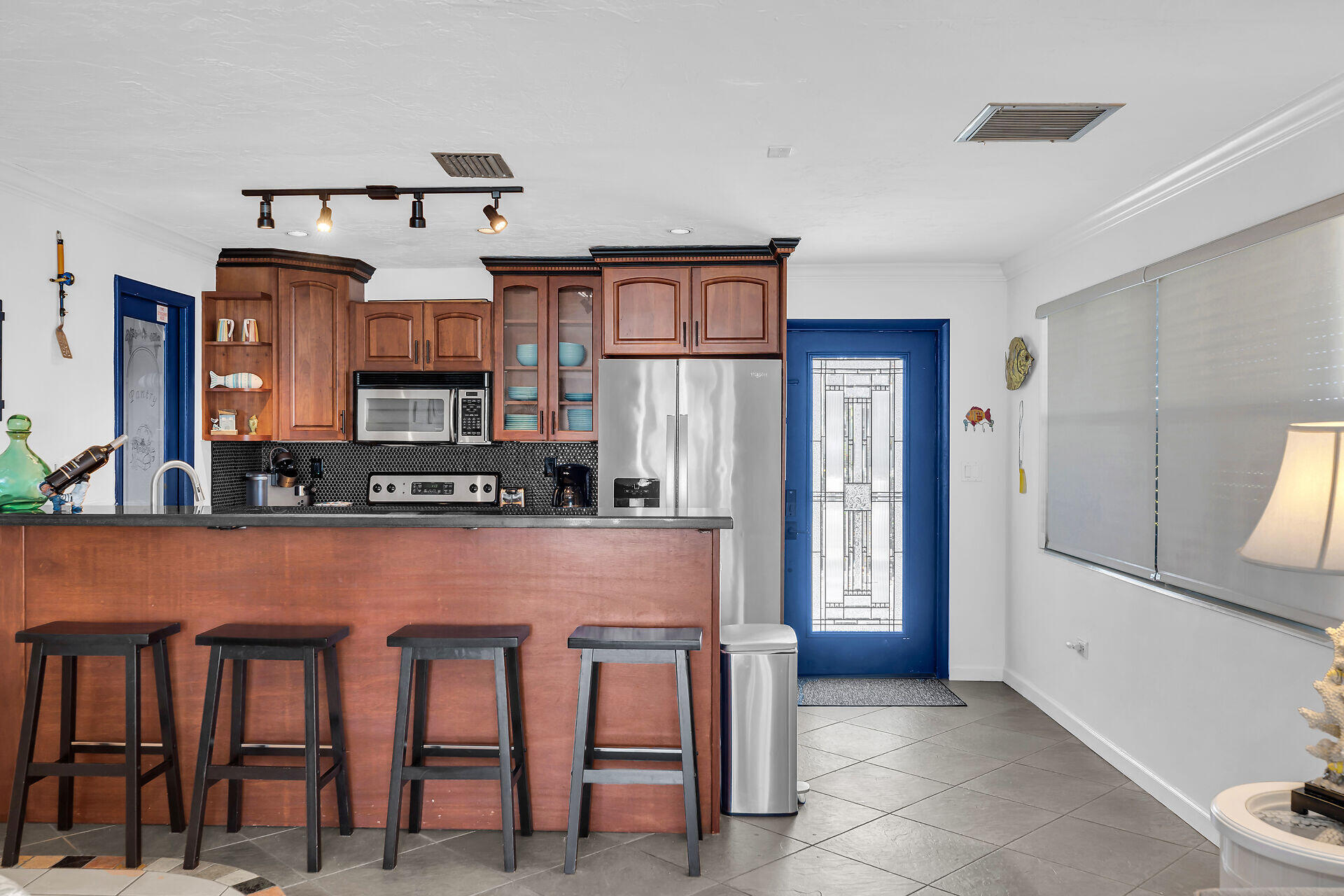 230 11th Street Key Colony Beach, FL 33051 - Photo 15 of 44 a kitchen with stainless steel appliances granite countertop a stove top oven a sink and a refrigerator