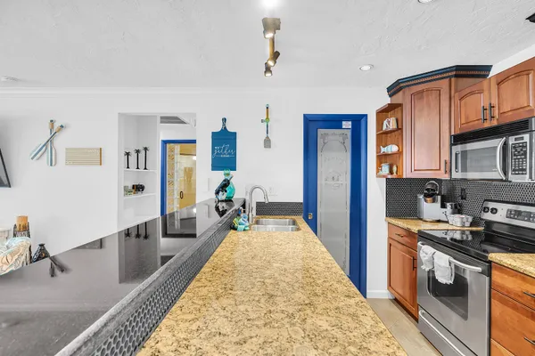 a bathroom with a granite countertop sink toilet a mirror a vanity and shower