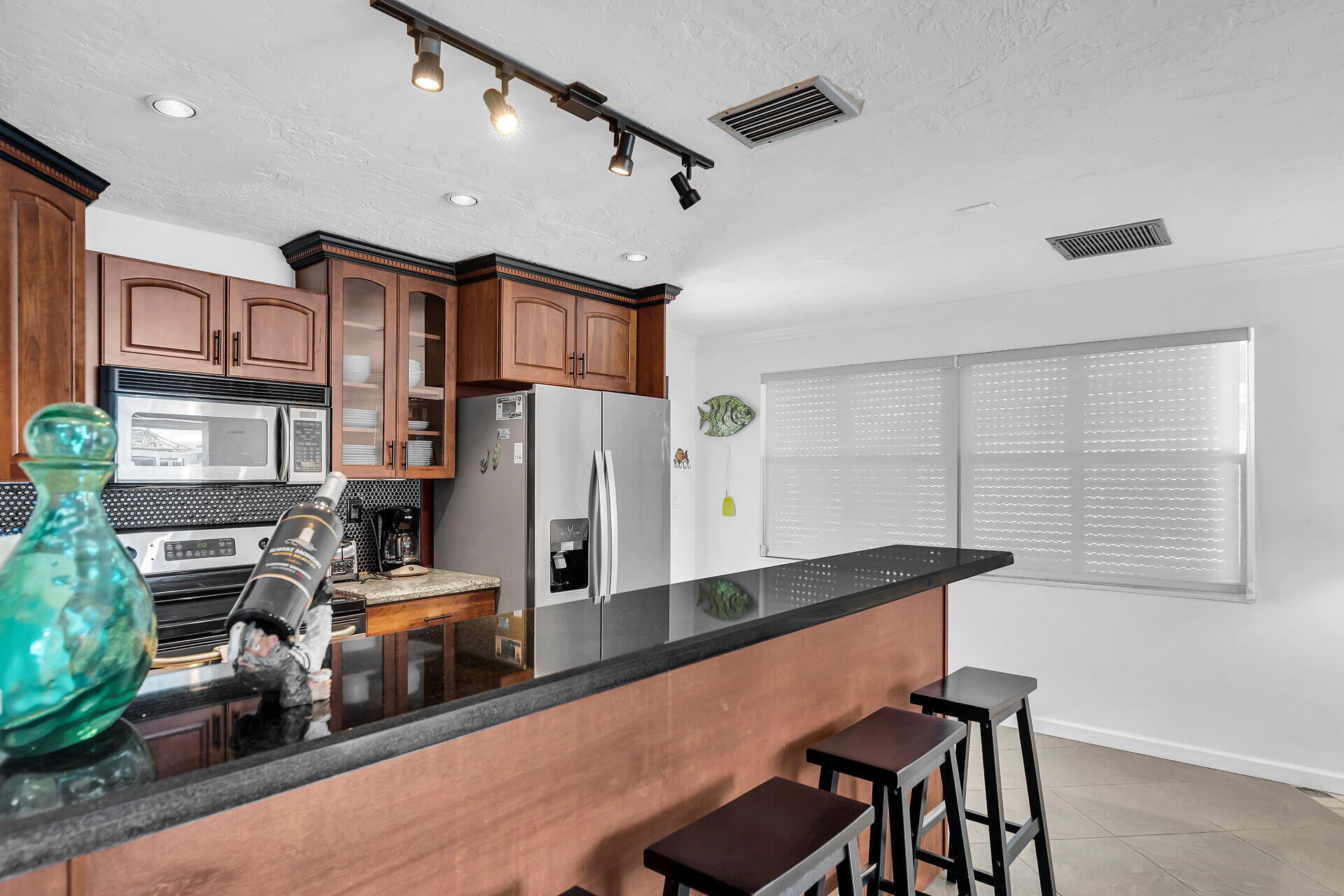 230 11th Street Key Colony Beach, FL 33051 - Photo 20 of 44 a kitchen with stainless steel appliances granite countertop a refrigerator and a stove