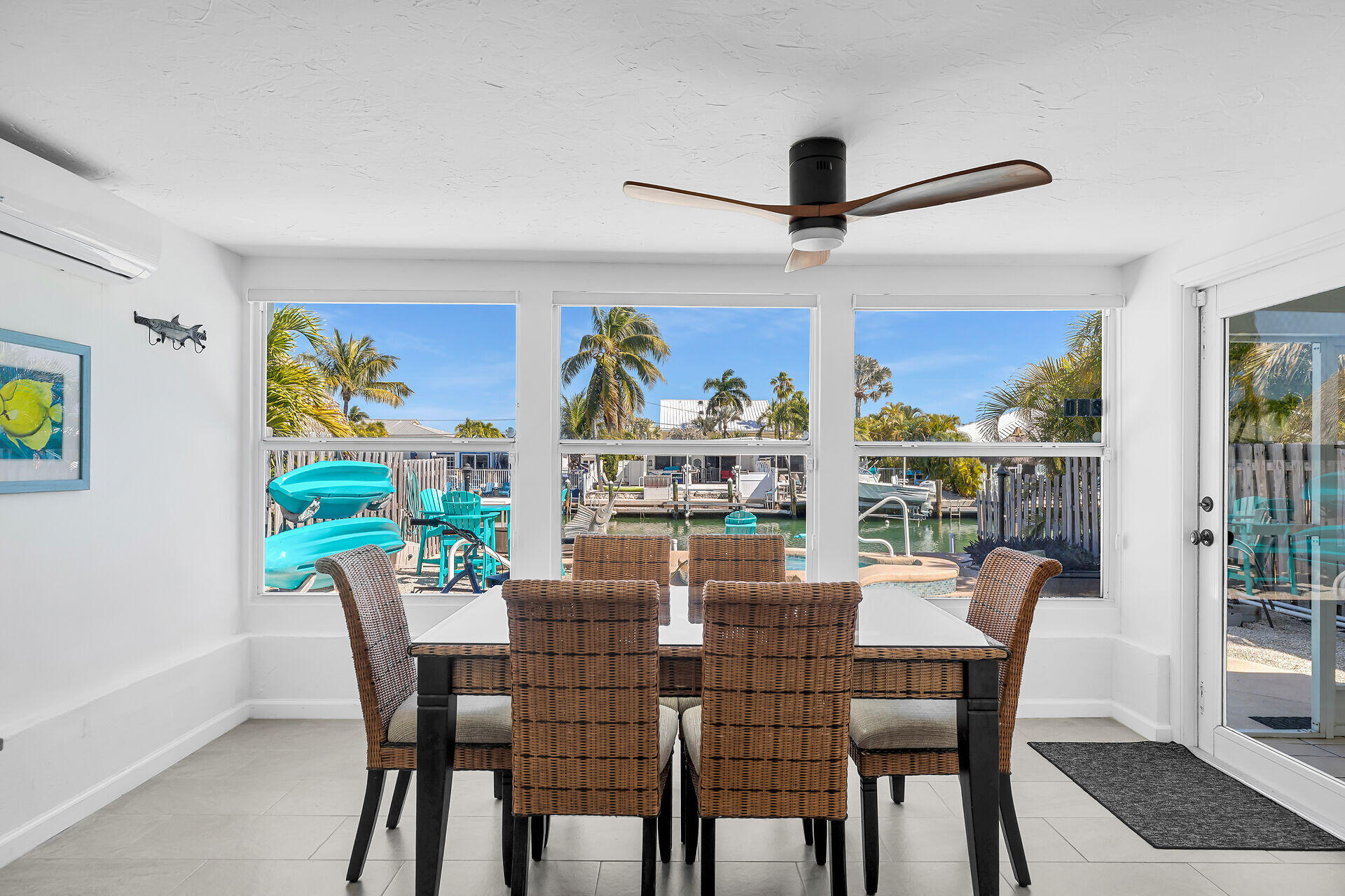 230 11th Street Key Colony Beach, FL 33051 - Photo 24 of 44 a dining room with furniture a rug and a floor to ceiling window