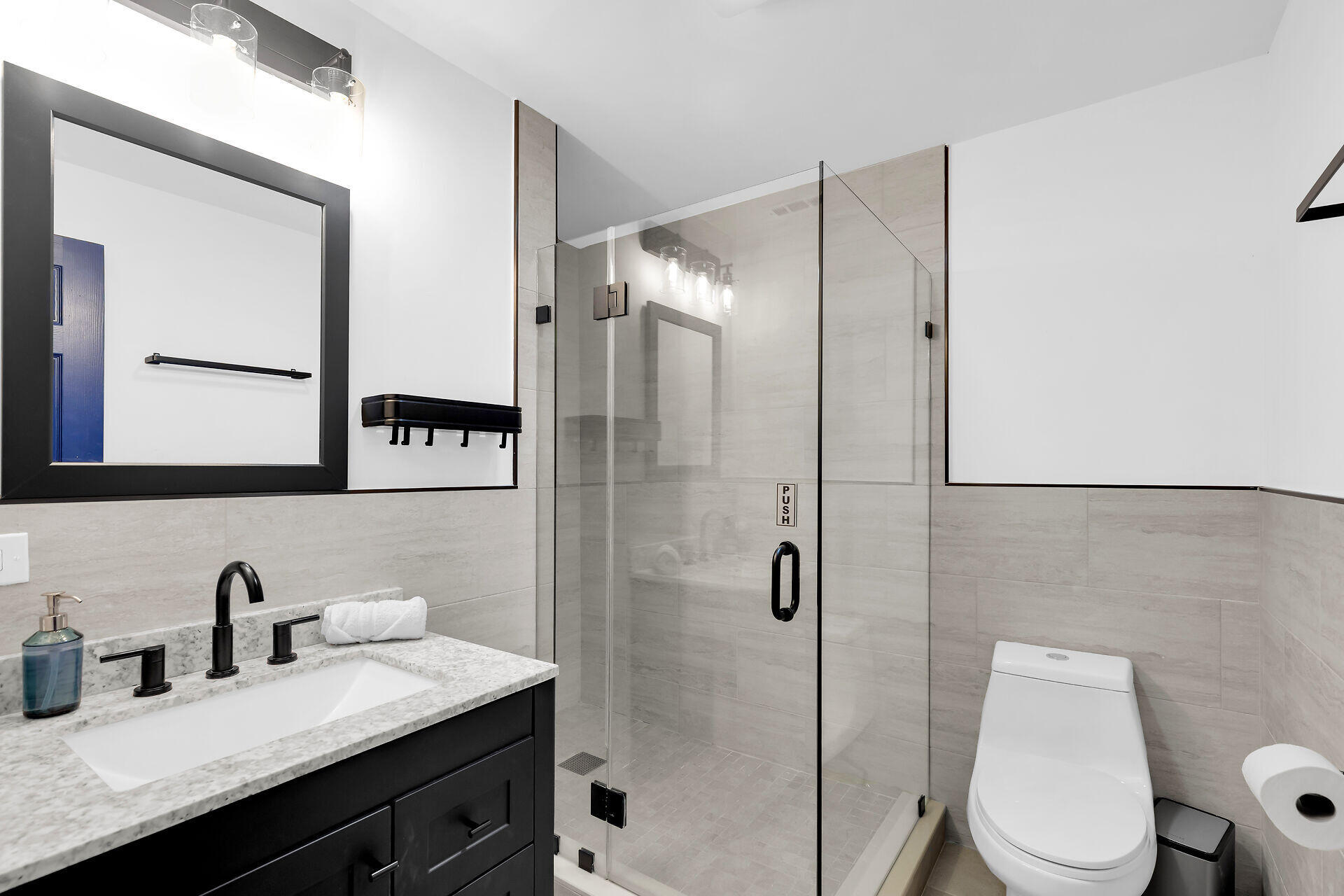 230 11th Street Key Colony Beach, FL 33051 - Photo 29 of 44 a bathroom with a granite countertop sink toilet a mirror a vanity and shower