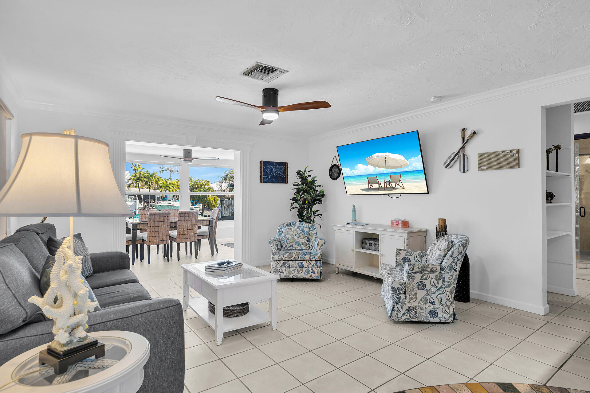 230 11th Street Key Colony Beach, FL 33051 - Photo 3 of 44 a living room with furniture and a lamp