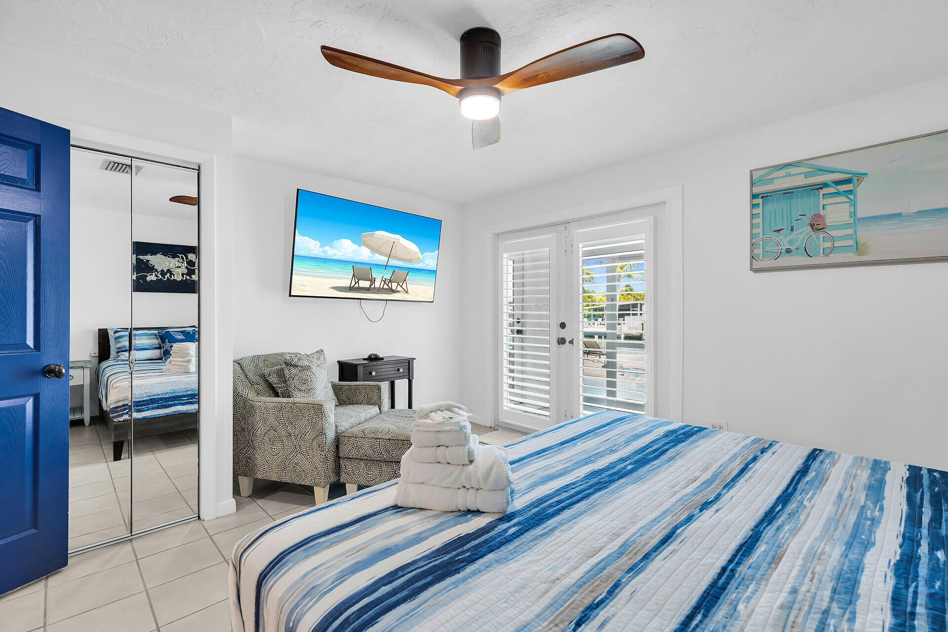 230 11th Street Key Colony Beach, FL 33051 - Photo 32 of 44 a bedroom with a bed and a chandelier