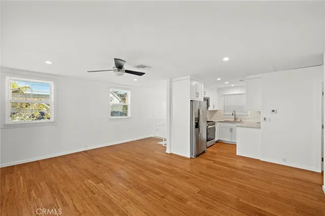 a kitchen with white cabinets and appliances