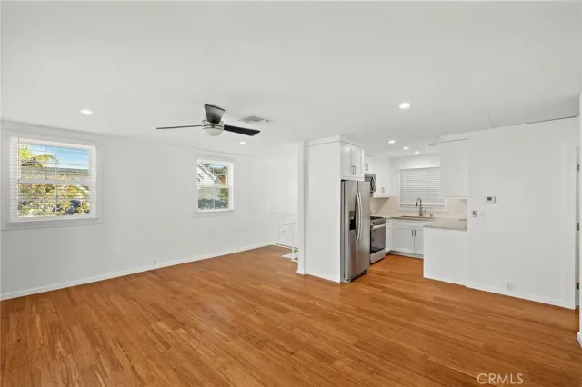 a view of a kitchen with a sink and a refrigerator