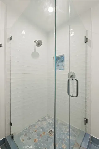 a view of a room with wooden floor and a window