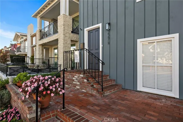 a view of a patio with a table and chairs and potted plants