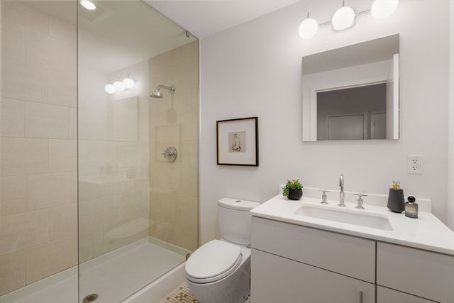 a bathroom with a sink a toilet and shower