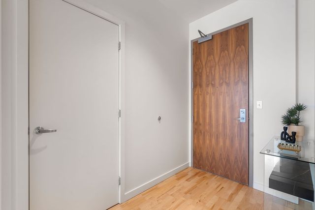 a view of an entryway with wooden floor