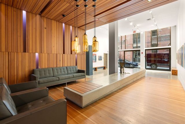 a living room with furniture and large windows