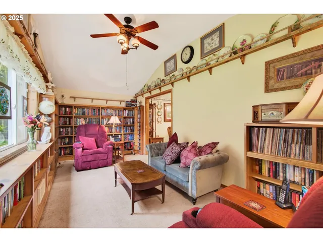 a living room with furniture and a book shelf