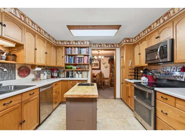 a kitchen with lots of counter top space and stainless steel appliances