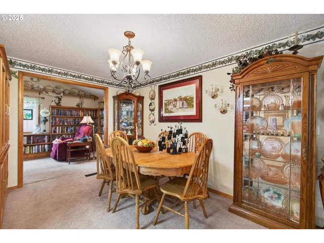 a view of a dining room with furniture and chandelier