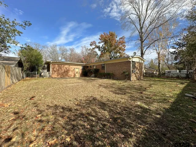 a view of a yard with large trees