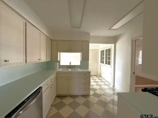 a kitchen with stainless steel appliances a sink stove and cabinets