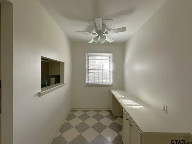 a view of an empty room with windows