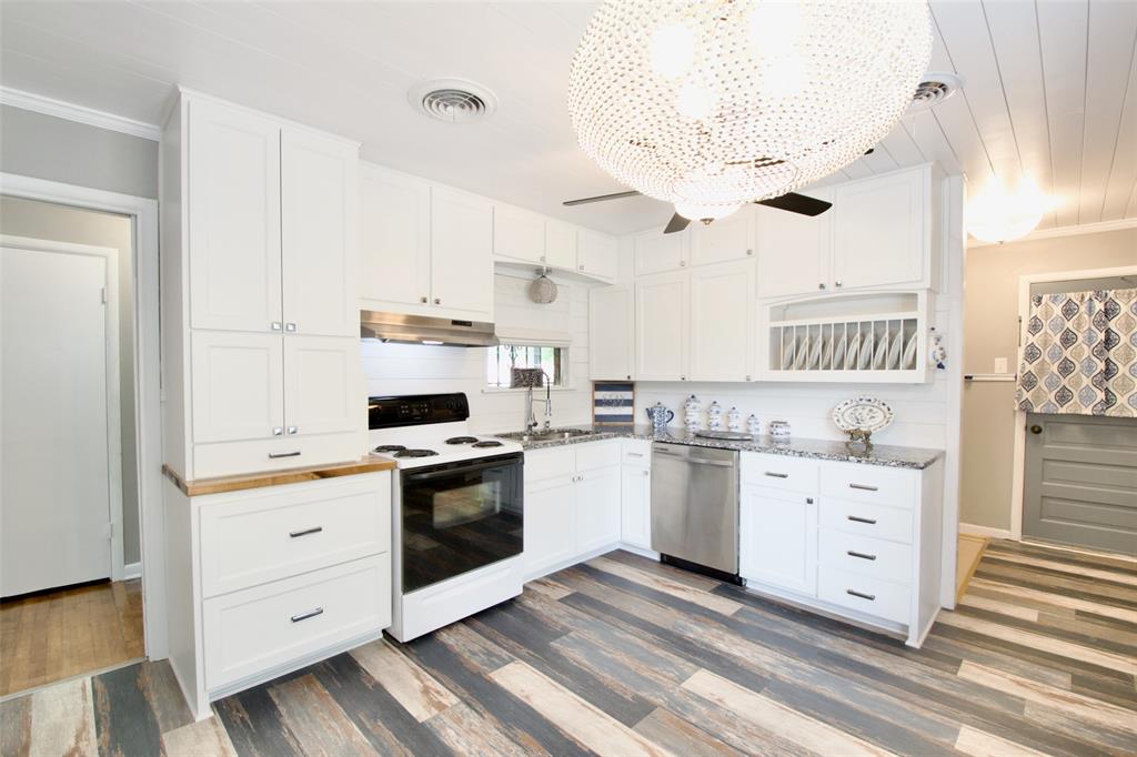 1307 North 65th Street Waco, TX 76710 - Photo 11 of 35 a kitchen with white cabinets and white appliances