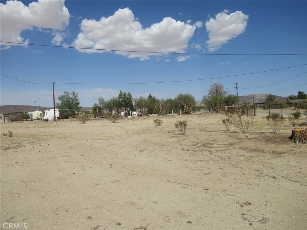 64654 Sun Mesa Road Joshua Tree, CA 92252 - Photo 20 of 25 a view of a beach with a yard