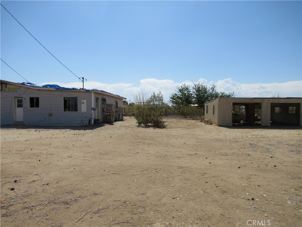64654 Sun Mesa Road Joshua Tree, CA 92252 - Photo 21 of 25 a view of a house with a yard