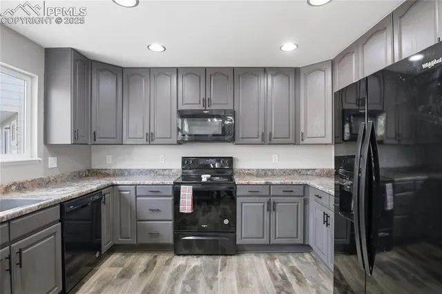 a kitchen with a sink stove and refrigerator