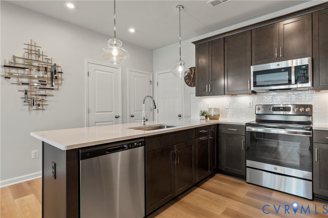 3611 Edna Path, Unit A Richmond, VA 23233 - Photo 2 of 32 a kitchen with stainless steel appliances a sink stove and microwave