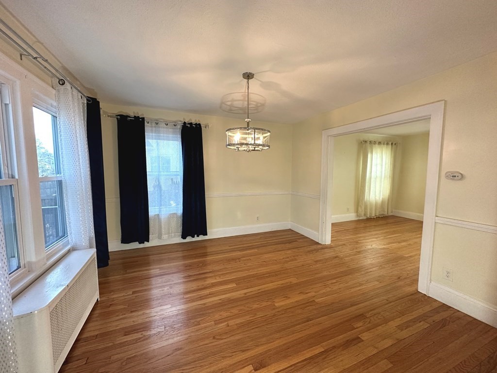 132 Maple Road Longmeadow, MA 01106 - Photo 8 of 29 an empty room with wooden floor and windows