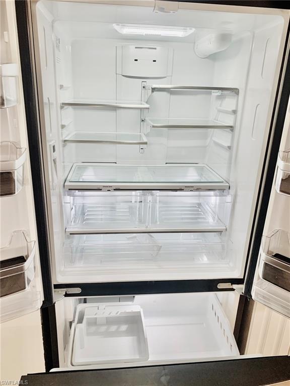 826 Wiggins Pass Road, Unit 214 Naples, FL 34110 - Photo 11 of 21 Kitchen view of white refrigerator