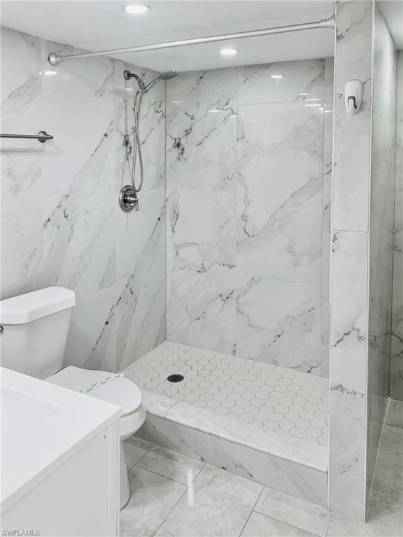 826 Wiggins Pass Road, Unit 214 Naples, FL 34110 - Photo 17 of 21 Bathroom with a marble finish shower and vanity