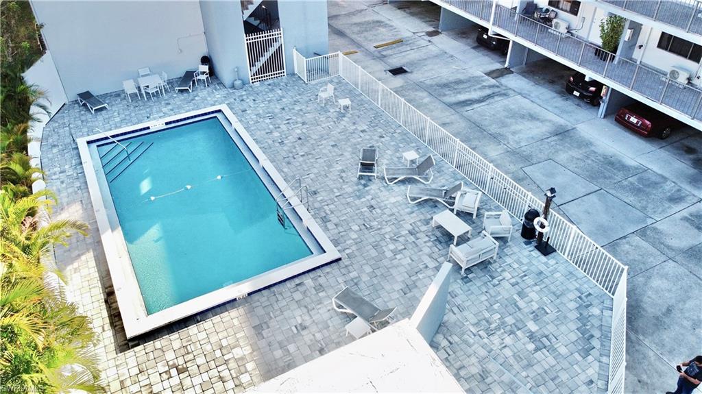 826 Wiggins Pass Road, Unit 214 Naples, FL 34110 - Photo 2 of 21 View of pool featuring a patio